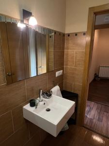 a bathroom with a white sink and a mirror at La Sabelona in Otero de Sanabria +31 photos