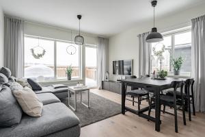 a living room with a couch and a table at Kungsberget Ski apartment 31C in Järbo