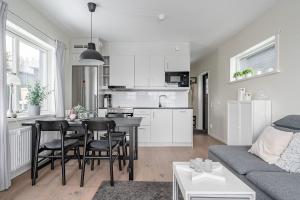 a kitchen and living room with a table and chairs at Kungsberget Ski apartment 31C in Järbo