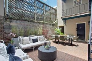 a patio with a white couch and a table at Cozy Charming Historic Home in Savannah