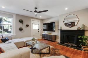 a living room with a couch and a fireplace at Cozy Charming Historic Home in Savannah