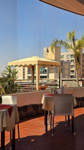 a couple of tables and chairs on a balcony at Ohasis Hotel Jujuy & Spa in San Salvador de Jujuy
