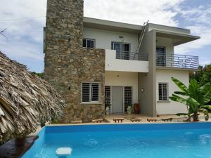 a villa with a swimming pool in front of a house at Casa Alegiu in Las Galeras