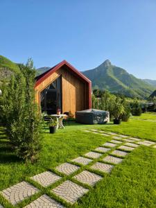 a stone path in a yard with a building at Dalmace Villas in Koman