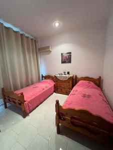 a bedroom with two beds and a sink at V&M Residence - Ground Level in Mesagrós +9 photos