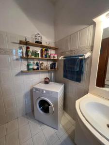 a washing machine in a bathroom next to a sink at V&M Residence - Ground Level in Mesagrós