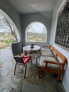 a room with chairs and a table and a window at V&M Residence - Ground Level in Mesagrós
