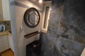 a bathroom with a shower with a mirror and a sink at Demetrius's Penthouse in Chalkida +28 photos