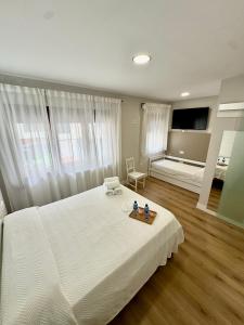 a bedroom with a large white bed with a tray on it at Valbanera in Colombres