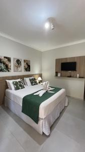 a bedroom with a large bed with a flower on it at Recanto 3ELLL in Bodoquena +55 photos