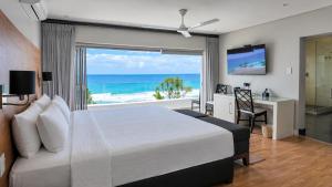 a bedroom with a bed and a view of the ocean at Vetho House Villa Ballito in Ballito