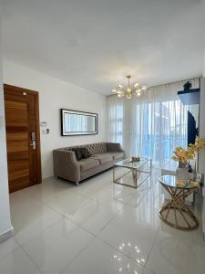a living room with a couch and a table at residencial enmanuel 1 in Hoya del Caimito