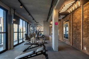 a gym with a row of treadmills and machines at Housi On Jardins in São Paulo