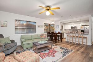 a living room with a couch and a table at 36 Bunker Court by Oak Island Accommodations in Caswell Beach