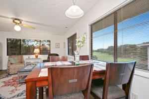 a dining room with a table and chairs at 36 Bunker Court by Oak Island Accommodations in Caswell Beach