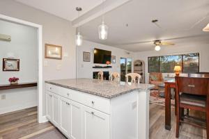 a kitchen with white cabinets and a counter top at 36 Bunker Court by Oak Island Accommodations in Caswell Beach +68 photos