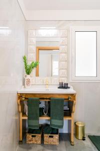a bathroom with a sink and a mirror at Casa Ti'Vina in Caniço