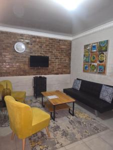 a living room with a couch and a table at Vista Ree Guesthouse Pty Ltd in Taung +5 photos