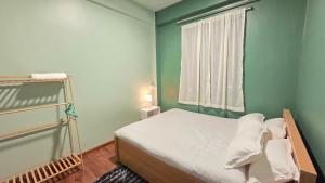 a small bedroom with a bed and a window at Celeste Inn in Shillong