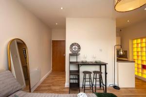 a room with a bed and a table with stools at Paradise Retreat in Cambridge +42 photos