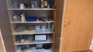 a room with a cabinet with dishes and a computer on it at Werreufer Loft in Detmold