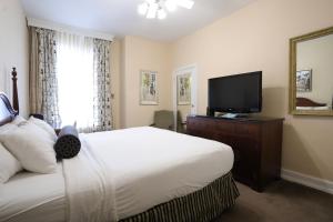 a bedroom with a bed and a flat screen tv at Arlington Resort Hotel & Spa in Hot Springs