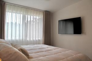 a bedroom with a bed in front of a window at Single Suite Unbeatable Location Internet b34 in Casa Blanca La Corregidora