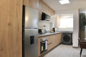a kitchen with a stainless steel refrigerator and a dishwasher at Single Suite Unbeatable Location Internet b34 in Casa Blanca La Corregidora