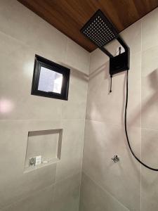 a bathroom with a shower with a window at Suite Home Sinop in Sinop