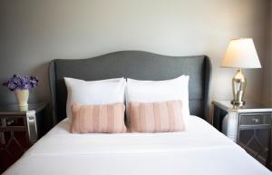 a bed with two pink pillows on top of it at The Hotel Hollywood in Los Angeles