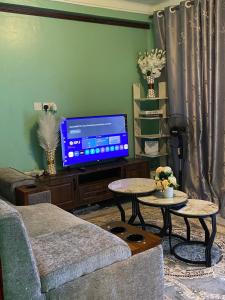 a living room with a couch and a tv at Flat in Jinja City in Jinja