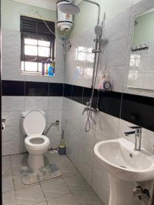 a bathroom with a toilet and a sink at Flat in Jinja City in Jinja
