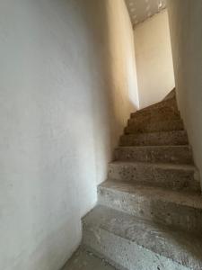 a staircase in an empty room with concrete steps at Perła pod Śnieżką in Miłków