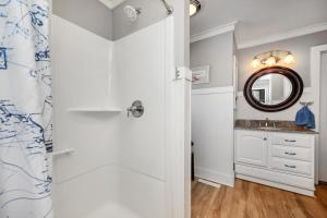 a bathroom with a shower and a sink at 7th Heaven by Oak Island Accommodations in Oak Island +68 photos