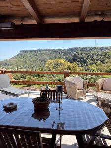 a table on a porch with a view of a mountain at Villa Veronica in Sedini
