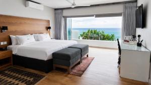 a bedroom with a bed with a view of the ocean at Vetho House Villa Ballito in Ballito +48 photos