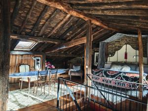 a room with a bed and a table and chairs at Casa Tejada in Rúerrero