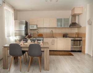 a kitchen with a wooden table and chairs in it at Active Homes in Veliko Tŭrnovo
