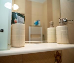 a shelf with three rolls of toilet paper in a bathroom at Active Homes in Veliko Tŭrnovo +12 photos