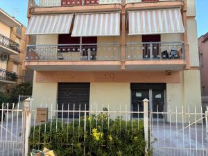 a building with balconies and a fence in front of it at Dayana House in Gallipoli