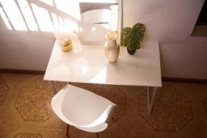 a white table with a plant and a mirror at Destiny Seaside in Content +27 photos