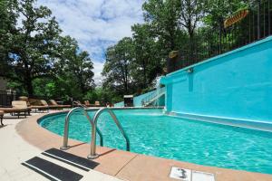 a large swimming pool with a blue building at Arlington Resort Hotel & Spa in Hot Springs