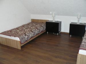 a bedroom with a bed and two night stands at Centro bustas in Kėdainiai