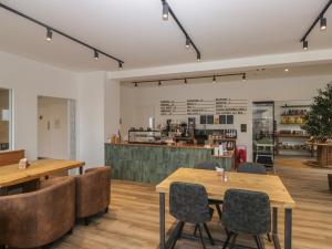 a restaurant with wooden tables and chairs and a counter at Pod No 28 in Keswick