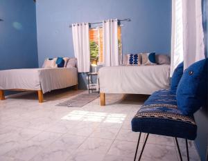 a blue room with two beds and a window at Destiny Seaside in Content