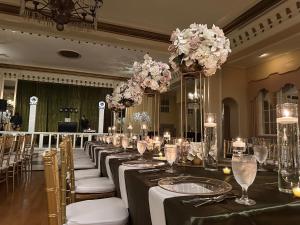 a long row of tables in a room with flowers at Arlington Resort Hotel & Spa in Hot Springs +63 photos