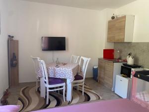 a kitchen with a table and chairs in a room at Riverside in Virpazar +25 photos