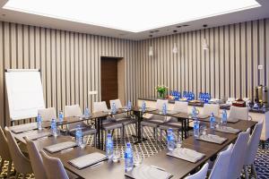 a meeting room with a long table and chairs at Art Hotel's Sosnowiec in Sosnowiec