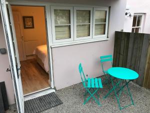 a room with a table and chairs and a bed at Palomar in Falmouth +6 photos