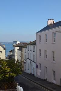 a city street with buildings and the ocean in the background at Palomar in Falmouth